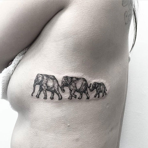 Line of Elephants Tattoo on Rib