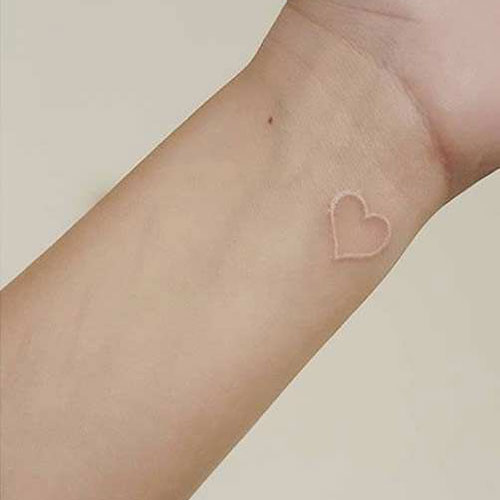 White Ink Heart Tattoo