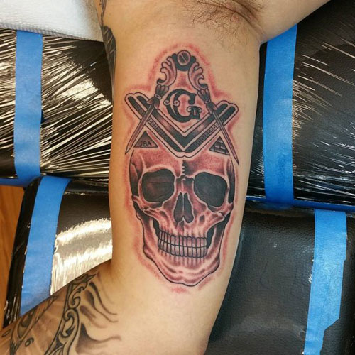 Badass Skull Inside Bicep Tattoo Designs
