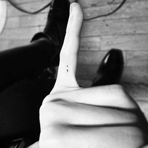 Tiny Semicolon Tattoo on Finger